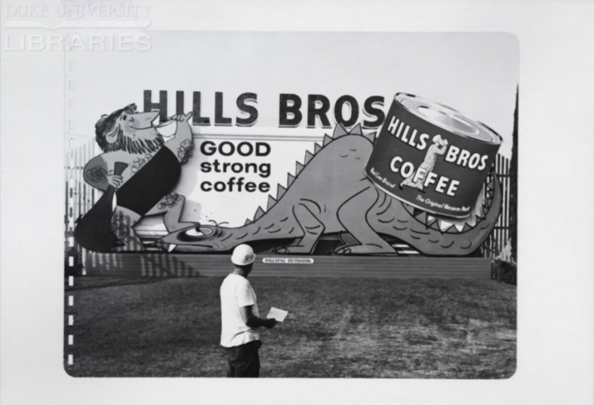 A man inspects a completed billboard for correctness.