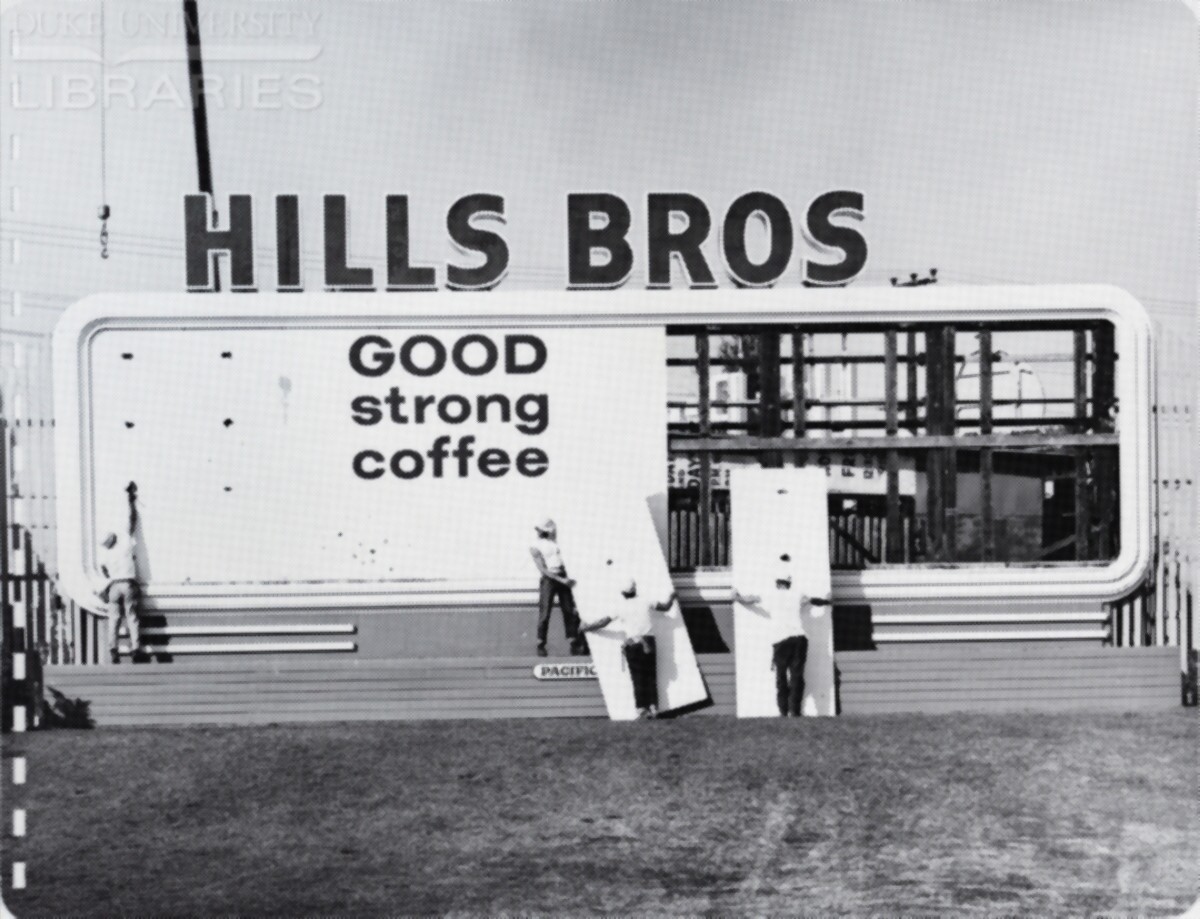 A crew installs billboard face panels.