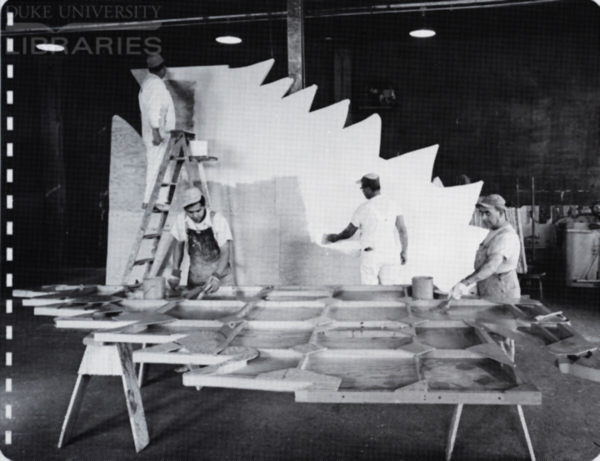 Billboard shop workers assemble and prime specialty wooden panels for final painting.