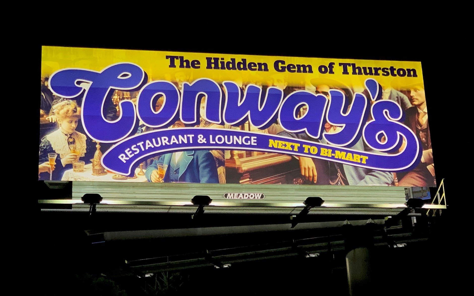 Billboard illuminated at night advertising Conway's Pub and Restaurant