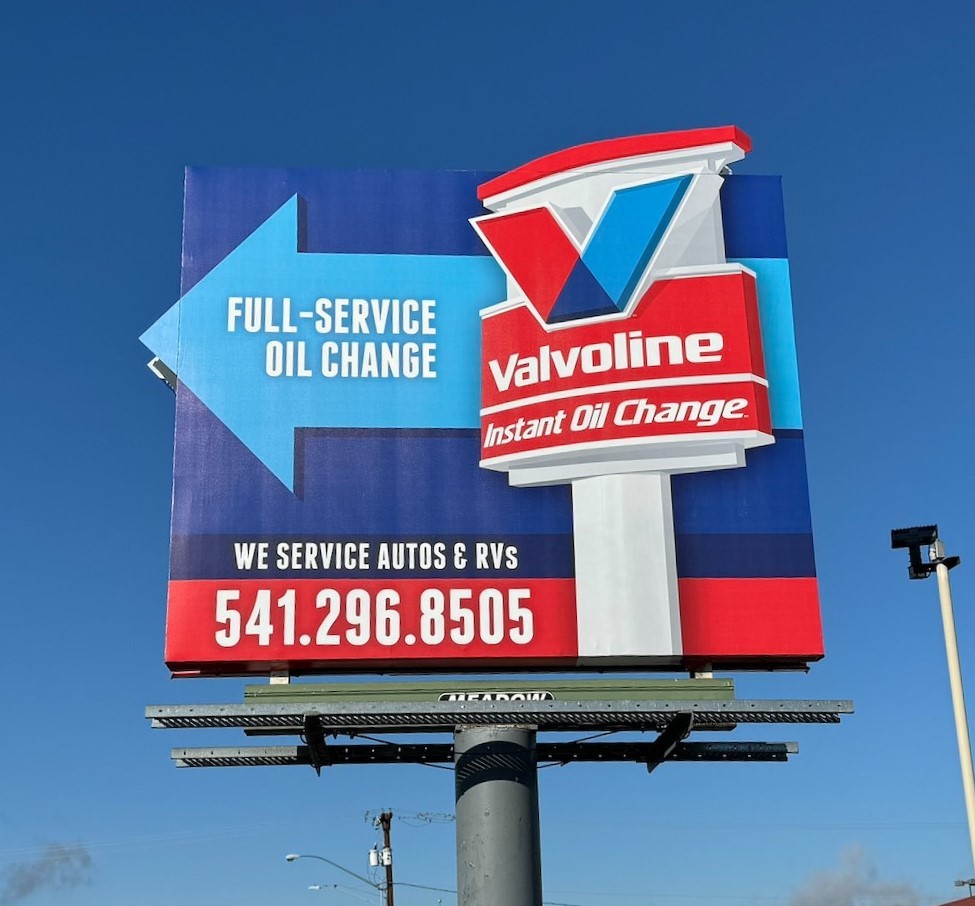 Small blue and red billboard advertising Valvoline Oil Change in The Dalles, Oregon