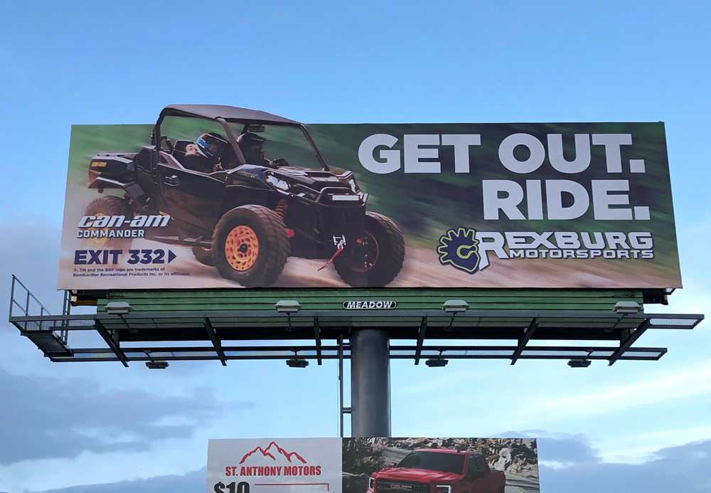 Meadow Outdoor Advertising Billboard displaying Rexburg Motorsports ad with ATV