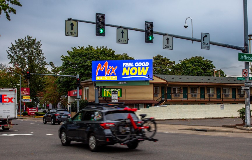 Meadow Outdoor Eugene Digital Billboard on 7th Ave with Cars passing by